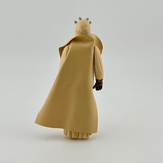 Action figure in all tan, wearing tan cape, brown gloves, brown belt, and tan wrapped face with mouthpiece.