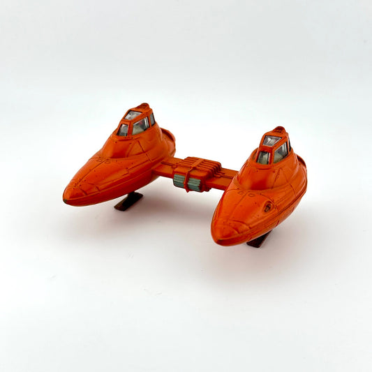 Orange toy spaceship on a white background