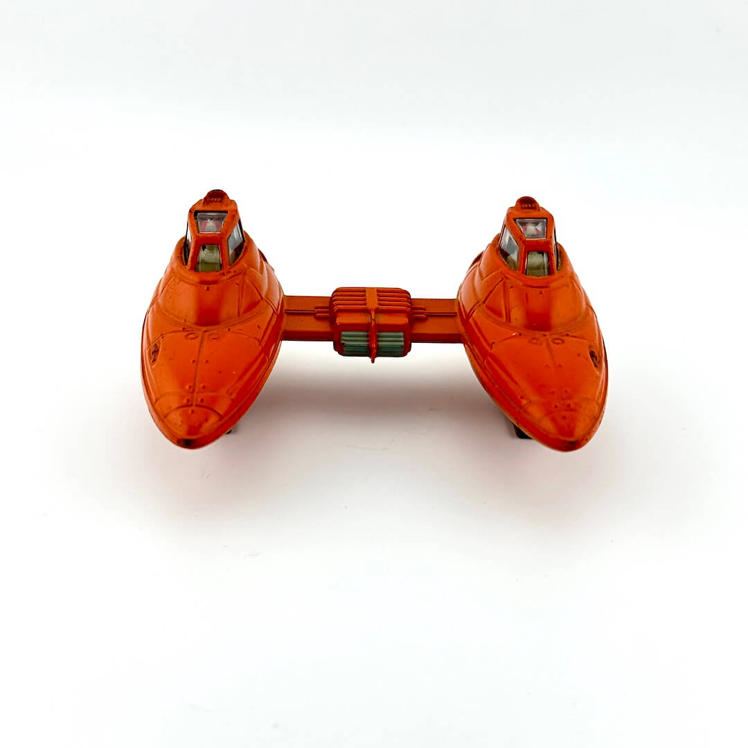 Orange toy spaceship on a white background