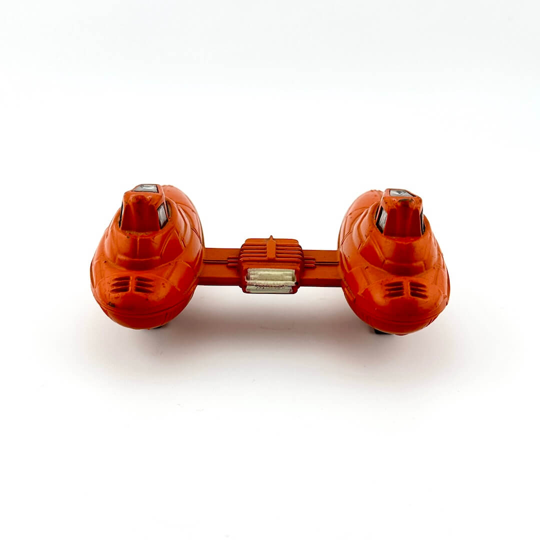 Orange dumbbell-shaped spaceship on a white background
