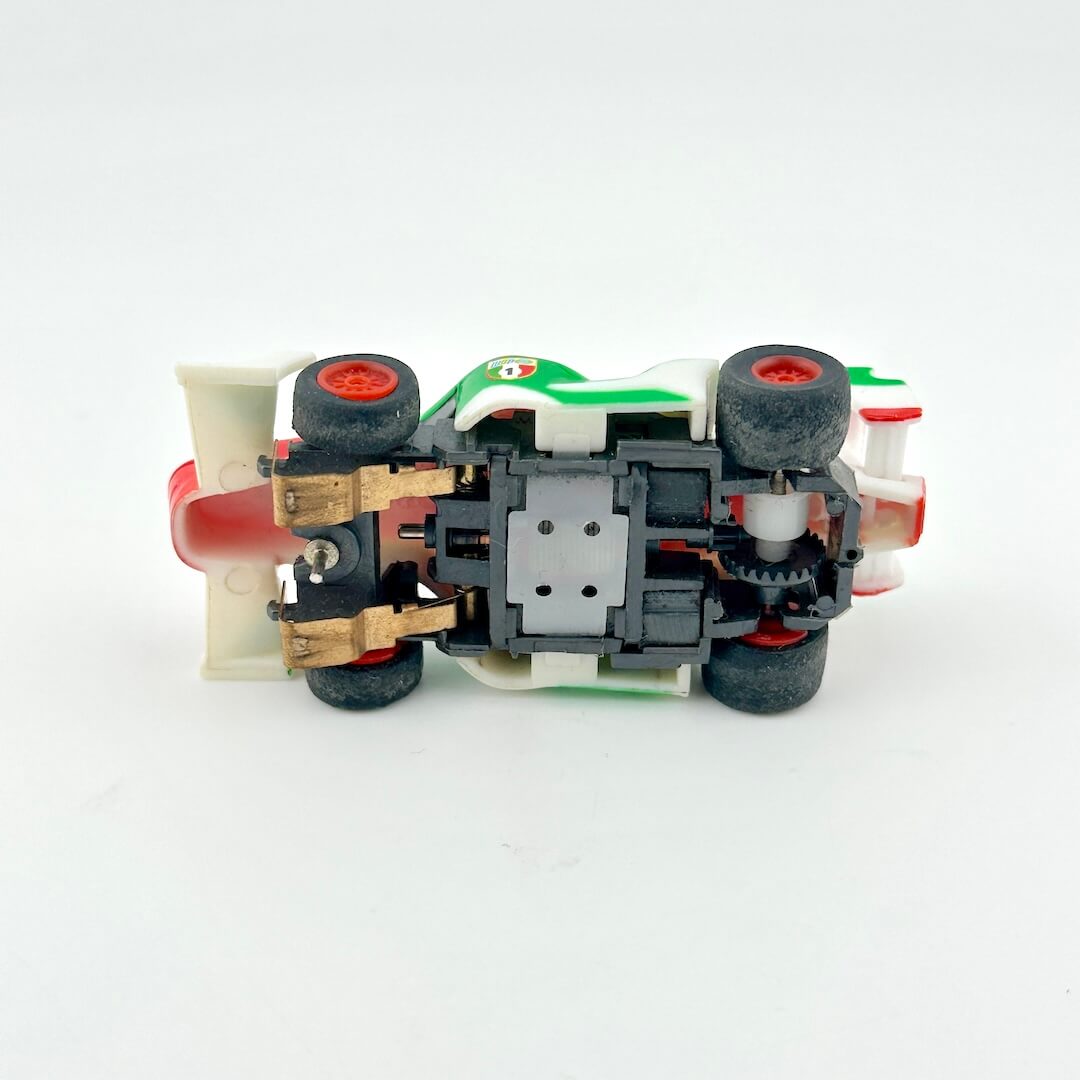 Toy car model with visible mechanical components on a white background