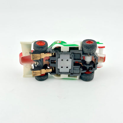 Toy car model with visible mechanical components on a white background