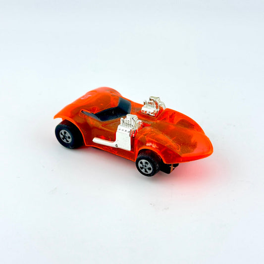 Small orange toy car on a white background