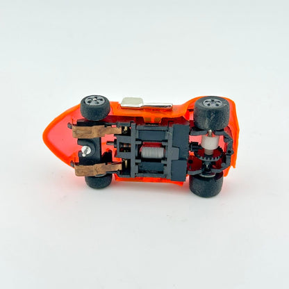Small mechanical model of a car with visible gears on a white background