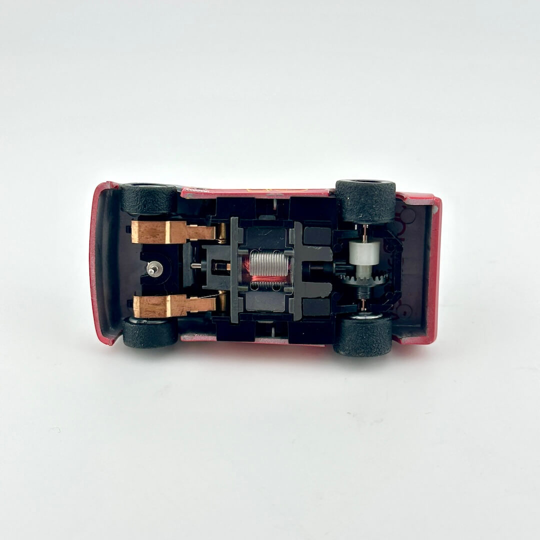 Underside of slot car to show electric components. 