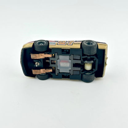 Toy car model with visible mechanical components on a white background