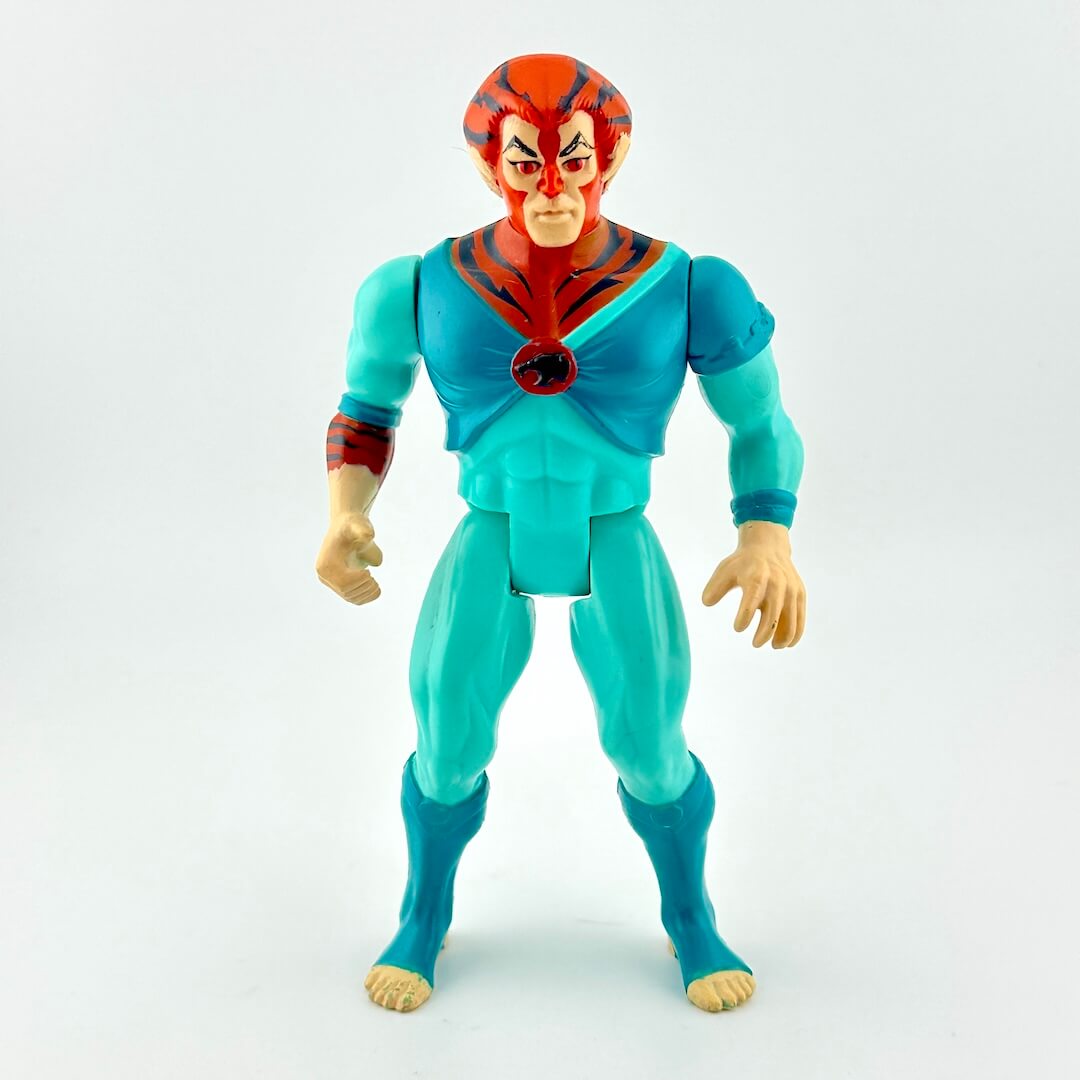 Action figure of male with tiger-like features in blue outfit against white background. 