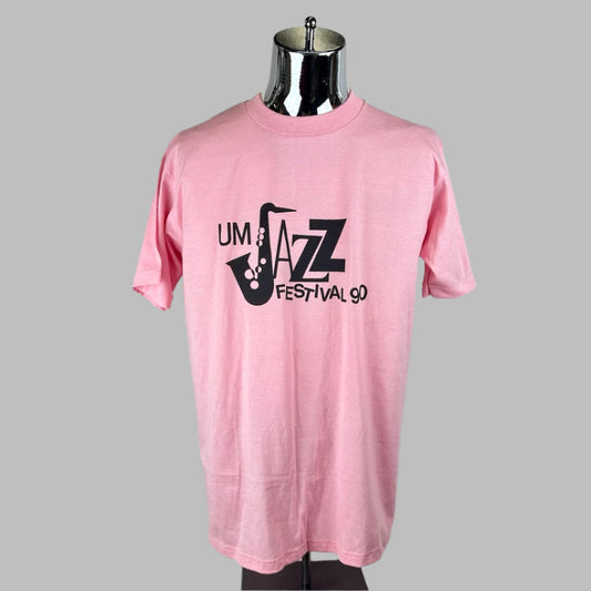 Light pink short sleeve t-shirt with black print "UM Jazz Festival 90" across chest with saxophone as J. 