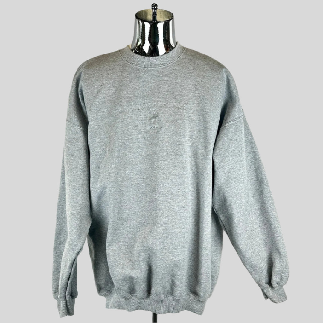 Front view of heather grey crewneck sweater with silver embroidery across chest with school & mascot name. 