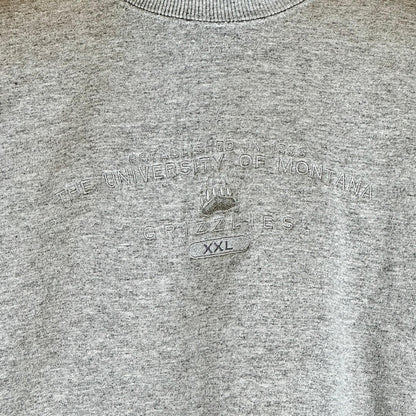 Close up of design on front embroidered in silver thread on heather grey sweater. School name above bear paw logo.