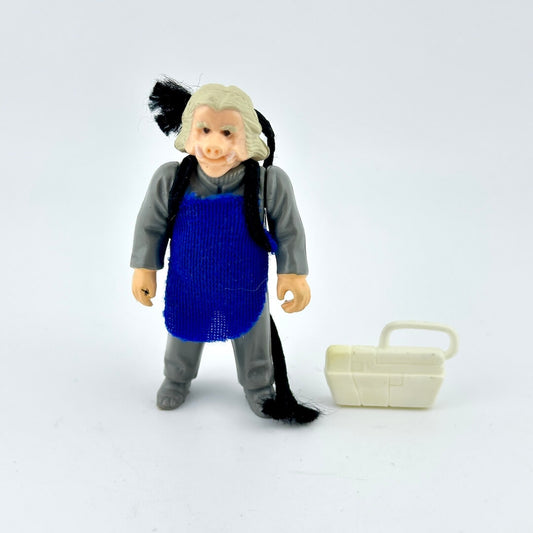 Toy figure of a character with a blue apron and gray outfit on a white background