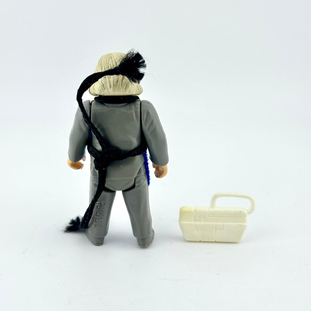 Toy figure of a character with an accessory on a white background
