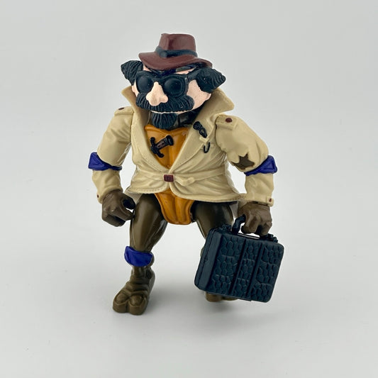 Anthropomorphized turtle wearing mask disguise, trenchcoat, fedora, with black briefcase. Front.