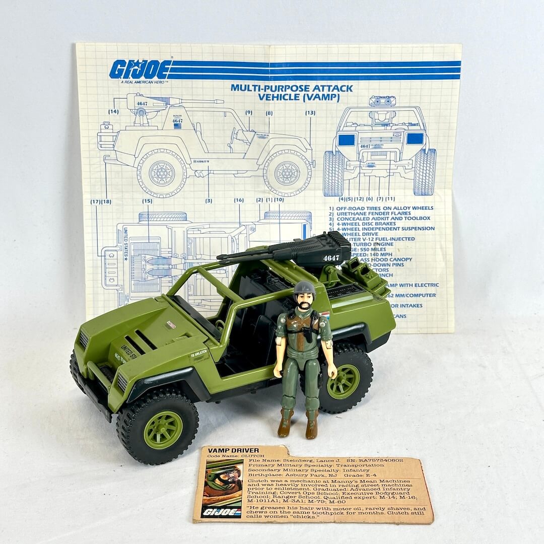 A vintage GI Joe VAMP toy set, including the olive green vehicle, a figure of the Vamp driver, instruction sheet, & a card.