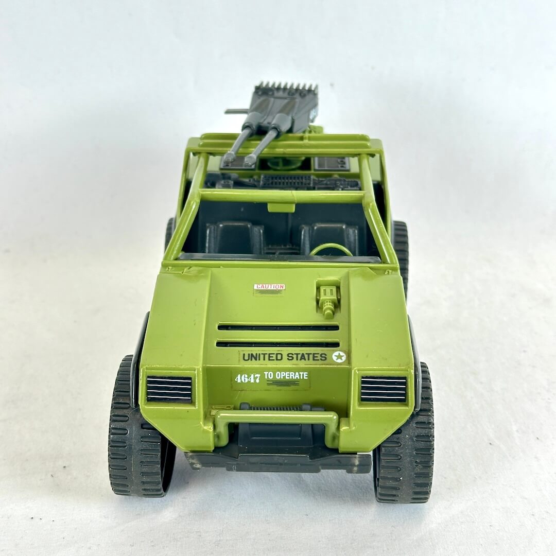A vintage green humvee toy vehicle with gray accents on white background. 
