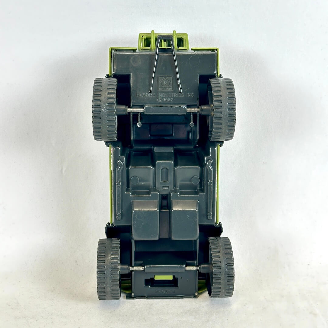 Underside of toy humvee with black chassis and embossed copyright information. 