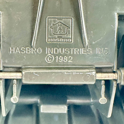Close-up of embossed HASBRO Industries Inc. branding on a dark gray molded plastic surface.