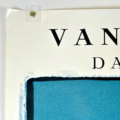 Top left corner of poster with creases at corner. 