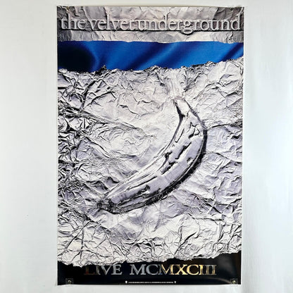 Poster of 'The Velvet Underground' album cover with crumpled paper texture and blue ribbon.