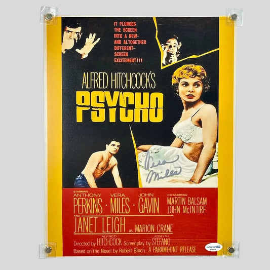 Photo of "Psycho" movie poster with signature in silver on light background. 