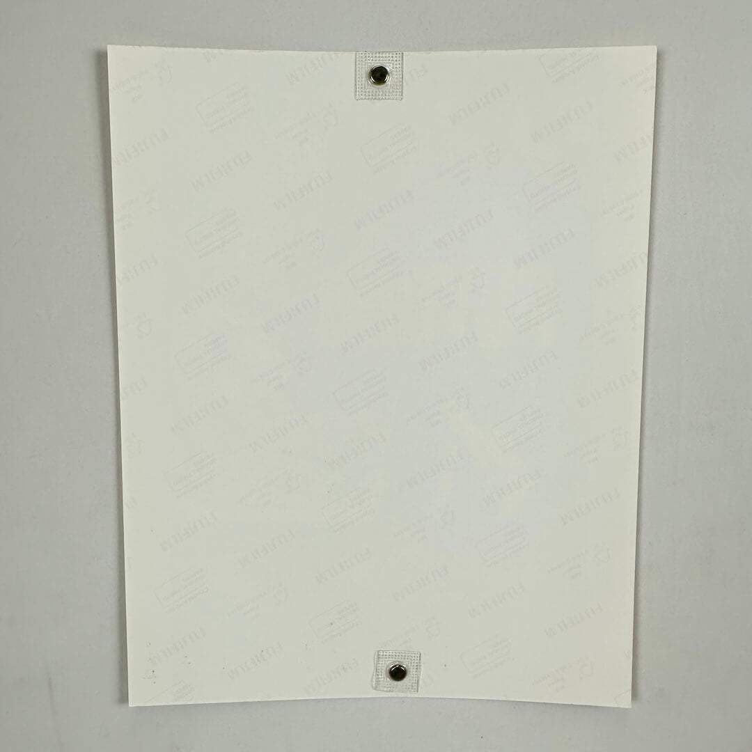 Backside of photo with watermarks for photo paper company on light background. 