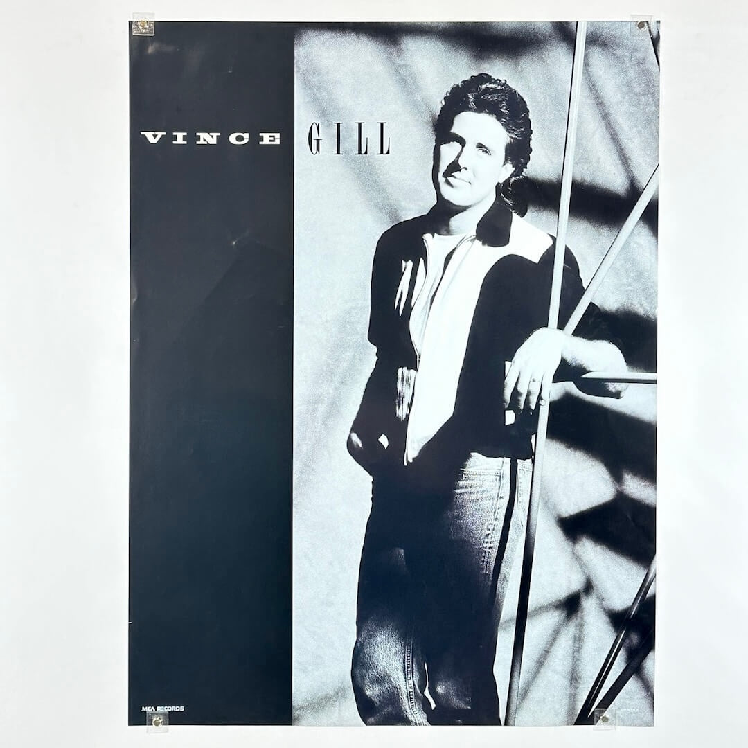 Poster with a black and white photo of a person, with 'Vince Gill' text.