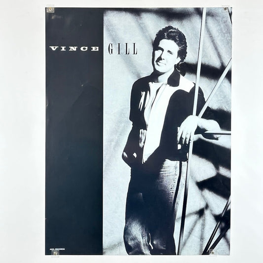 Poster with a black and white photo of a person, with 'Vince Gill' text.