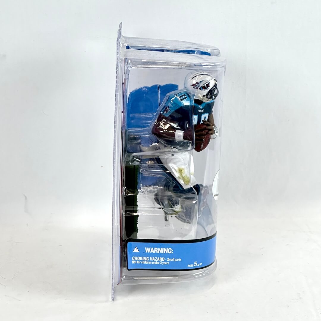 Toy figure of a football player in a clear packaging on a white background