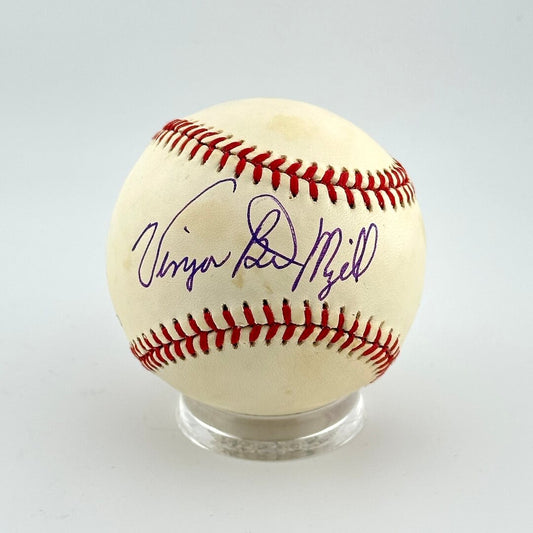 Baseball with autograph on a clear stand against a light gray background