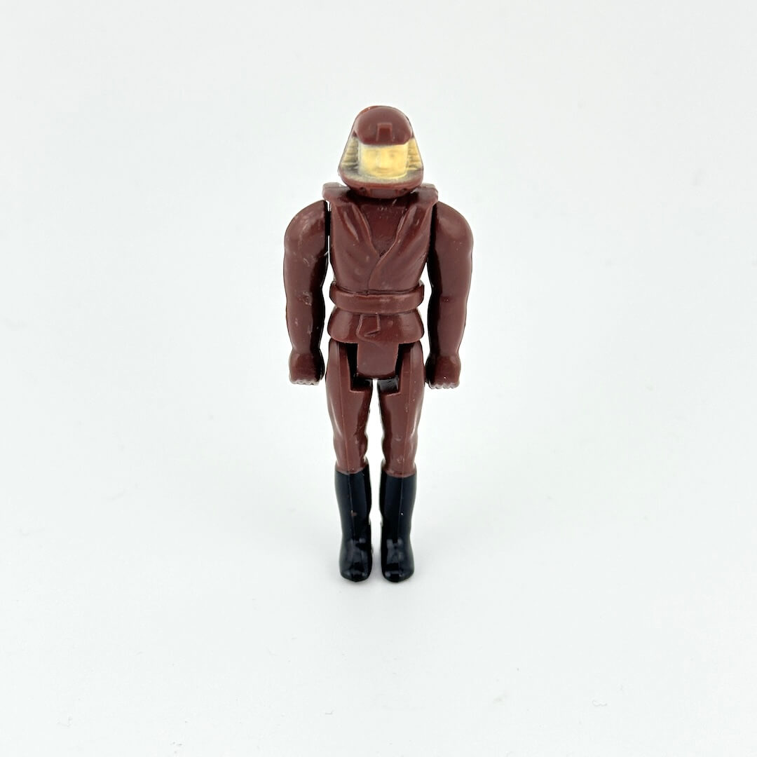 Action figure in brown flight suit with helmet on white background. 