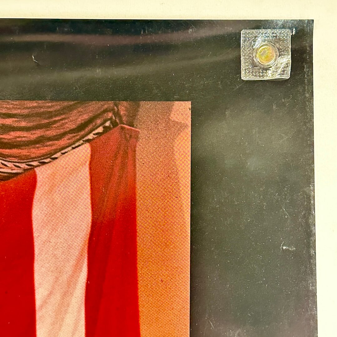 Top right corner of poster showing light scuffing to face. 