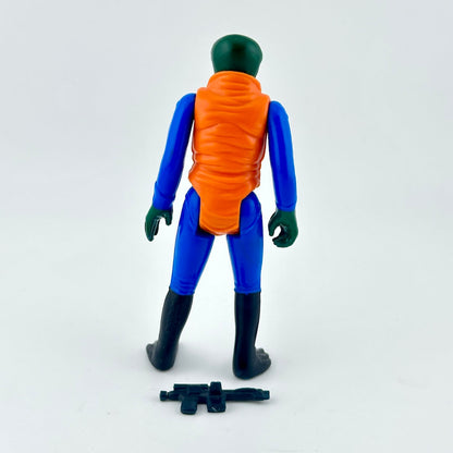 A vintage plastic action figure shown from the back, featuring a green head and hands, a blue body, and an orange vest. 