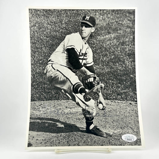 Black and white photo of a baseball player in action on a grass field