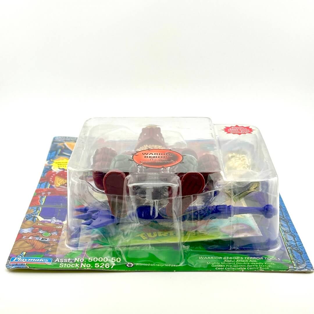 Toy figure in clear packaging on a colorful base with visible branding.