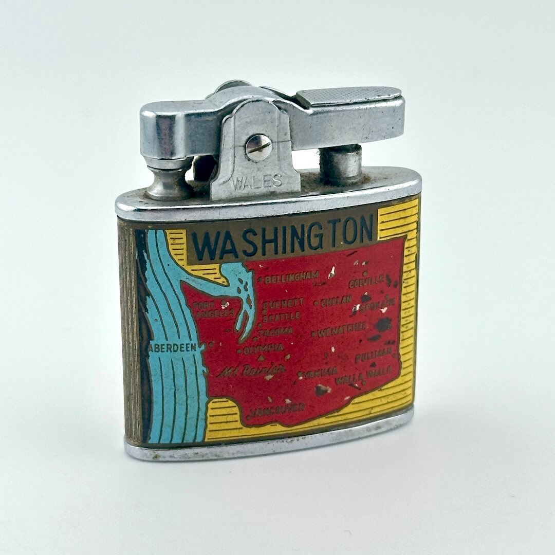 Vintage metal pocket lighter with Washington state map illustration. 