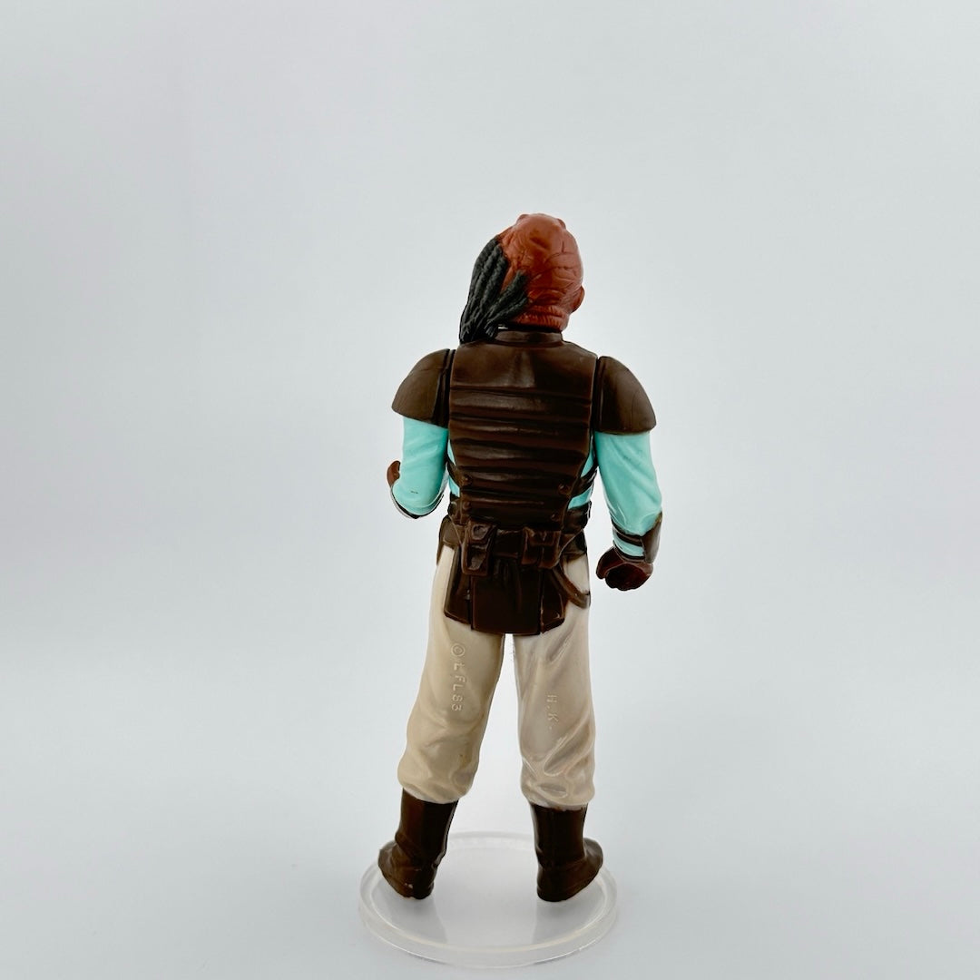 Figure is a 3.5 inch tall alien with dark orange wrinkled skin, long grey ponytail, brown armor over cyan shirt & tan pants.