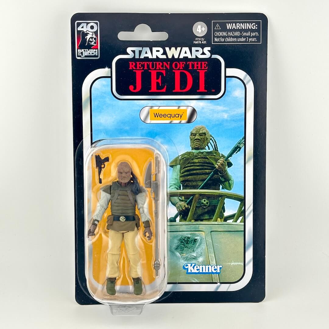 Star Wars action figure in its original blister packaging with retro-style card back; figure in brown vest and pants.
