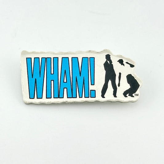 Vintage pin with blue text, "WHAM!" next to two silhouettes dancing. 