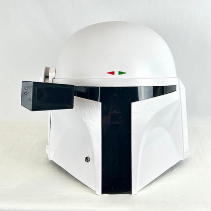 A white and black replica helmet inspired by the Mandalorian Trooper photographed on light background. 