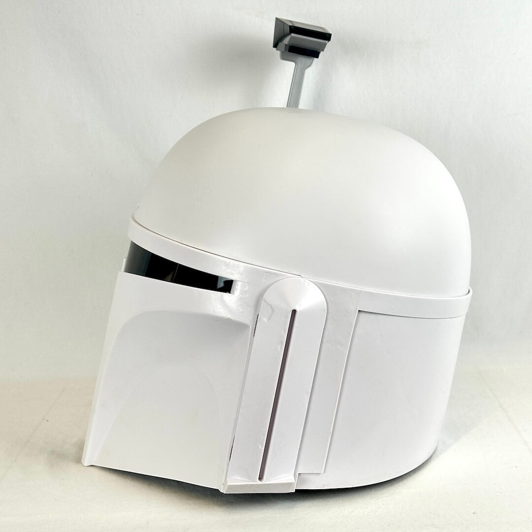 A white Mandalorian-style helmet replica with a black visor slit, photographed against a plain light background.