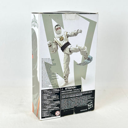 Back view of packaging with image of posed action figure and warning labels. 
