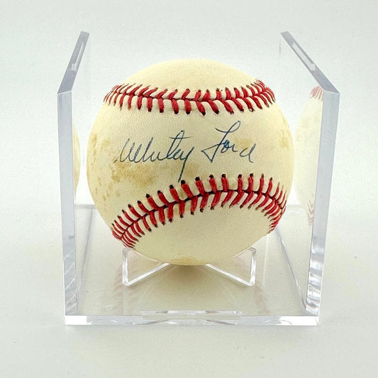 Signed baseball in clear display cube against white background.