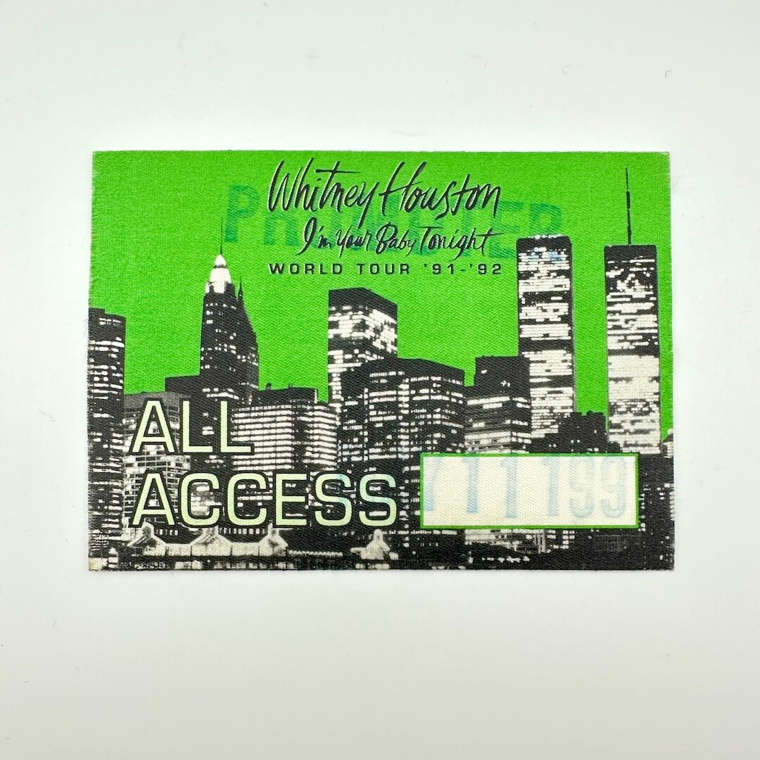 Promotional ticket for Whitney Houston's 'I'm Your Baby Tonight' world tour with a city skyline design.