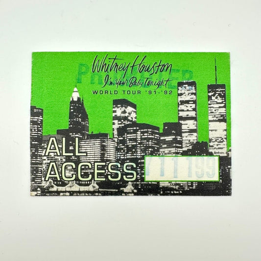 Promotional ticket for Whitney Houston's 'I'm Your Baby Tonight' world tour with a city skyline design.