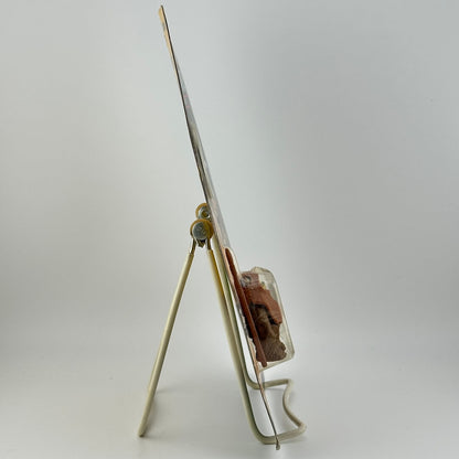 Side view of star wars action figure in packaging on easel against white background.