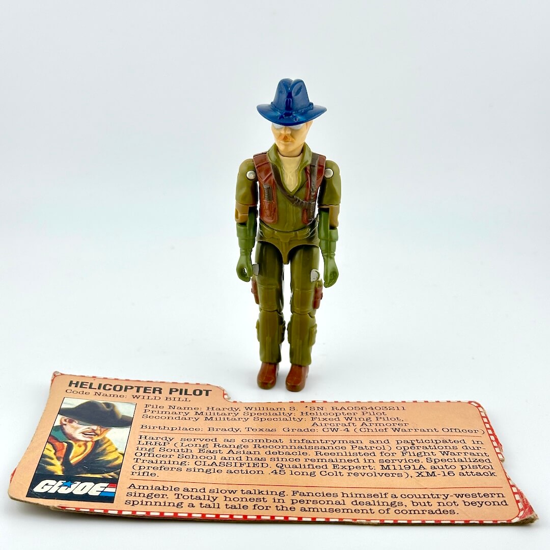 GI Joe action figure with card against white background. 