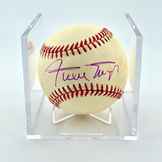 Signed baseball in clear display cube against white background. 