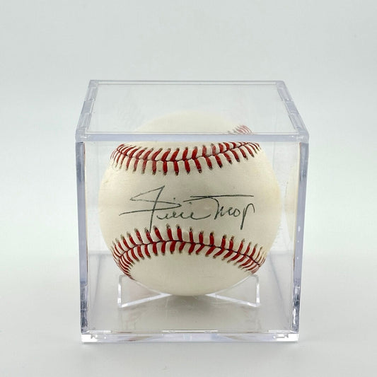 Autographed baseball in plastic cube with black pen signature across sweet spot.