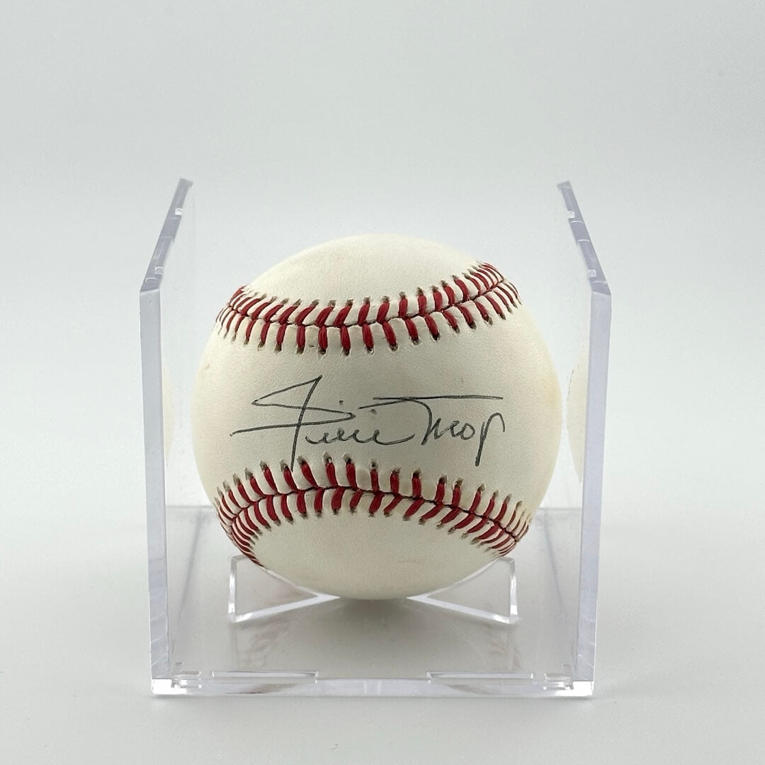 Autographed baseball in plastic cube with half of cube removed to show clear signature.