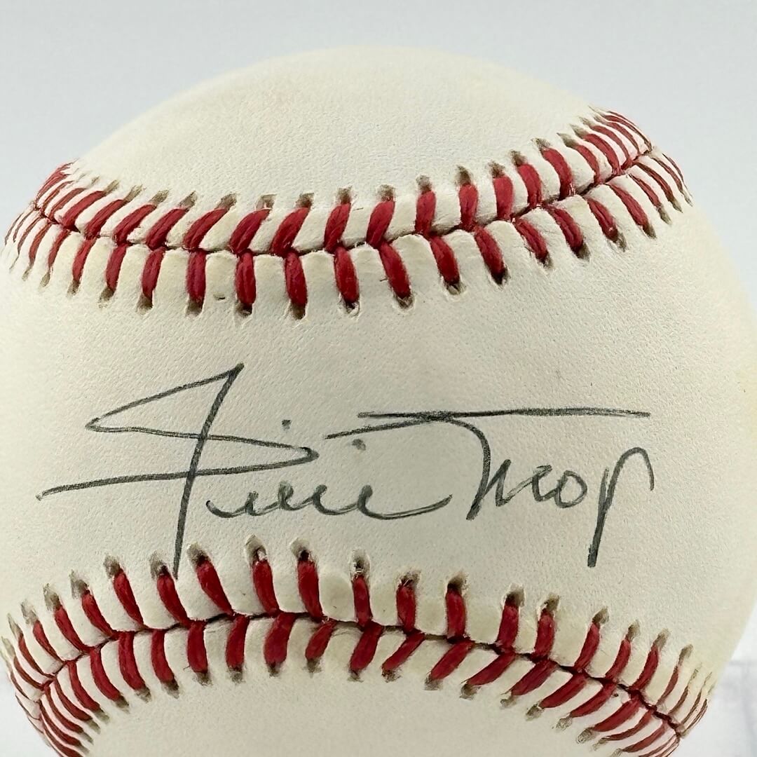 Close up of black pen signature in narrow section between red stitching, the "sweet spot." 